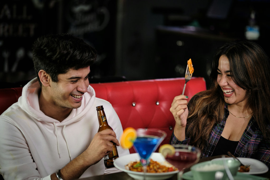 New compatible couple enjoying meal together